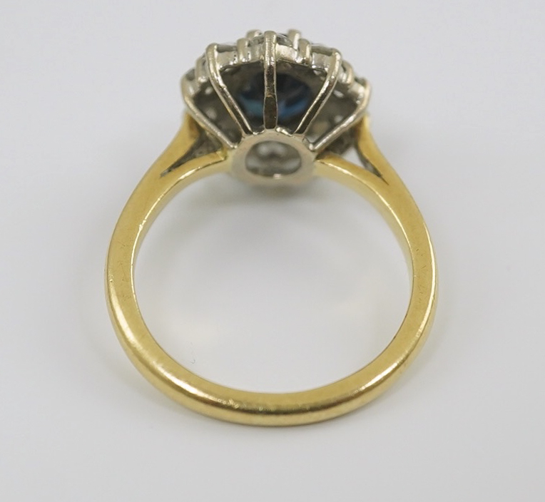 A modern 18ct gold, sapphire and diamond set oval cluster ring